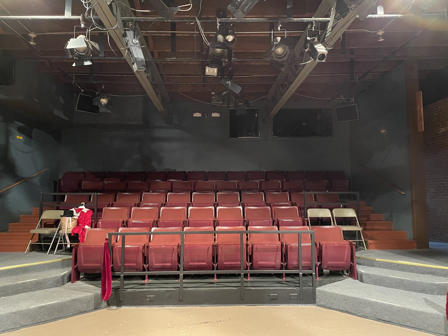 Center seating near the stage with the control room in the background.