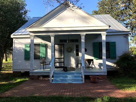 The front porch of the Arceneaux House. The home now has a center hallway from the front door to the back area which was added after the move in 1838 to adjoin the two halves together.