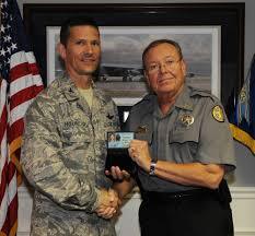 Col. Gerald Hounchell, 2nd Bomb Wing vice commander is presented with his new City Marshal I.D. badge given by Johnny Wyatt, Bossier Parish City Marshal