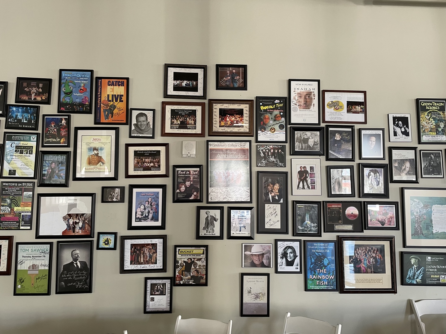 Framed headshots of previous performers and past playbills
