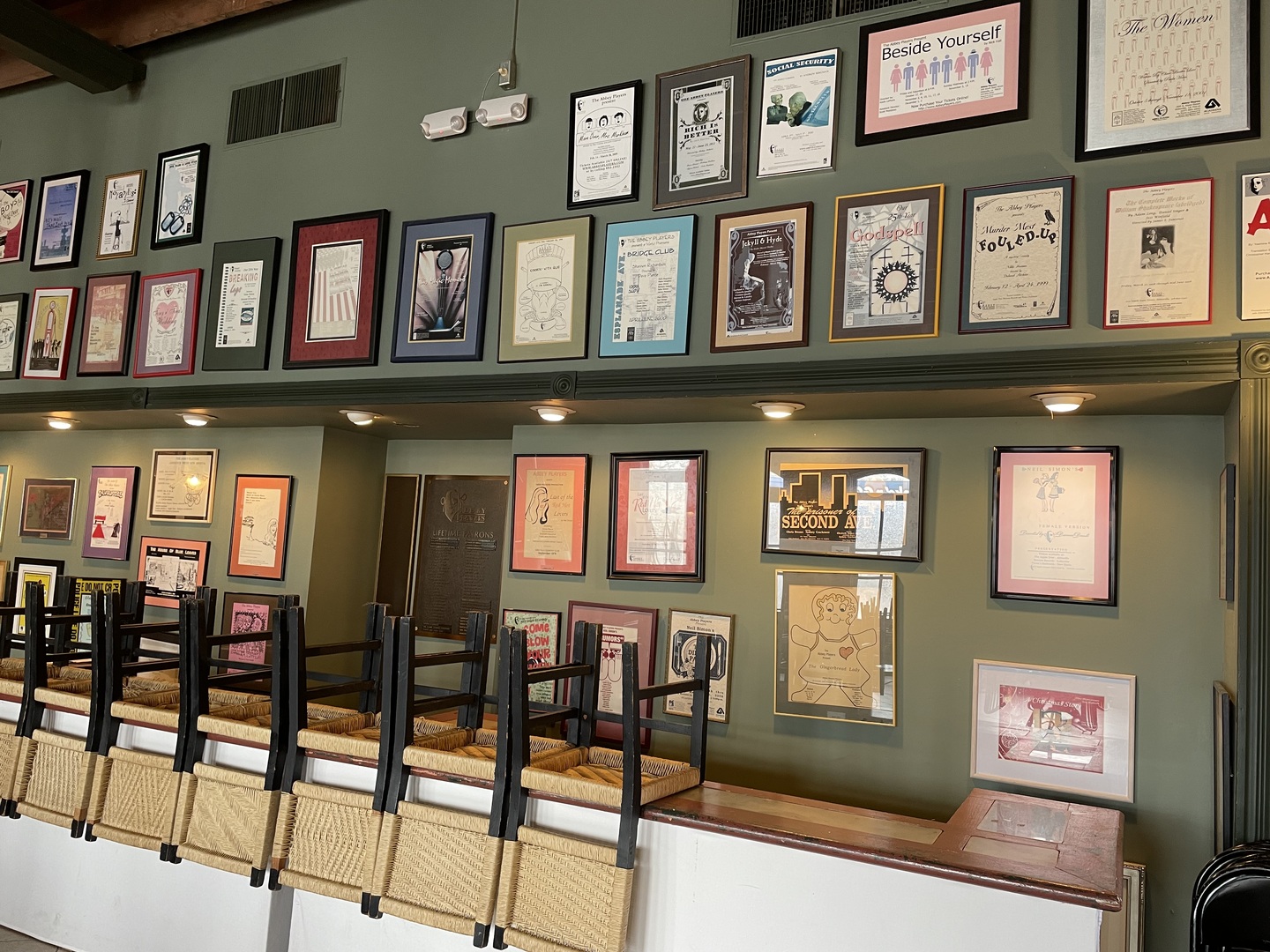 A view of the ticket area with old posters and photos on the wall.